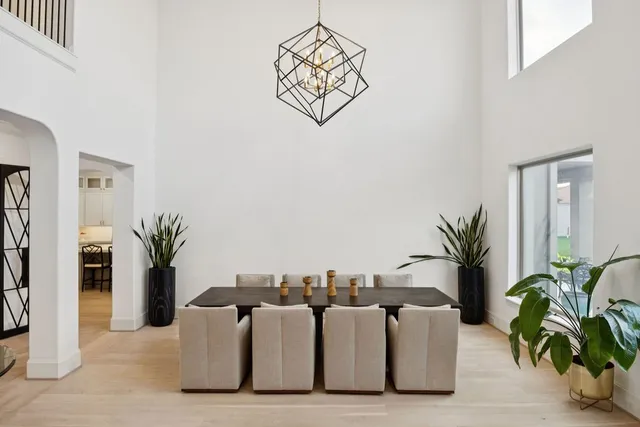 a large kitchen with kitchen island a large counter top space a sink a stove and a refrigerator