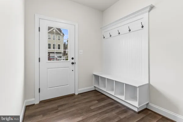 a view of a room with wooden floor and large window