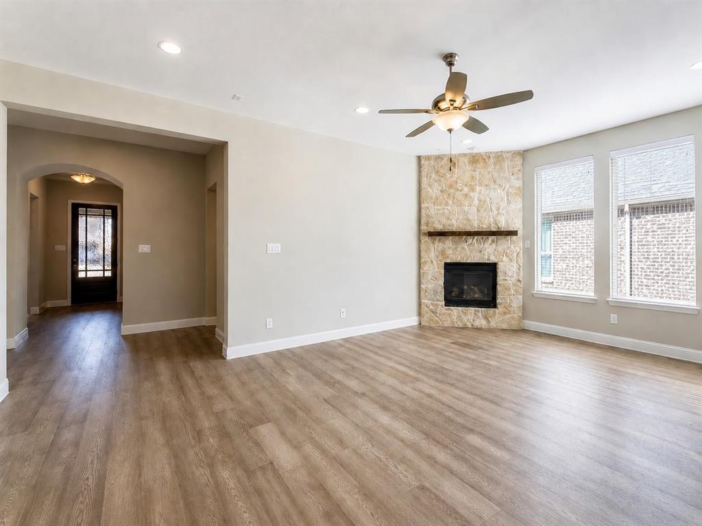 6209 Cupleaf Road Flower Mound, TX 76226 - Photo 7 of 29 Living area featuring wood-finish flooring, recessed lighting, and a corner stone-clad fireplace with a wood mantel