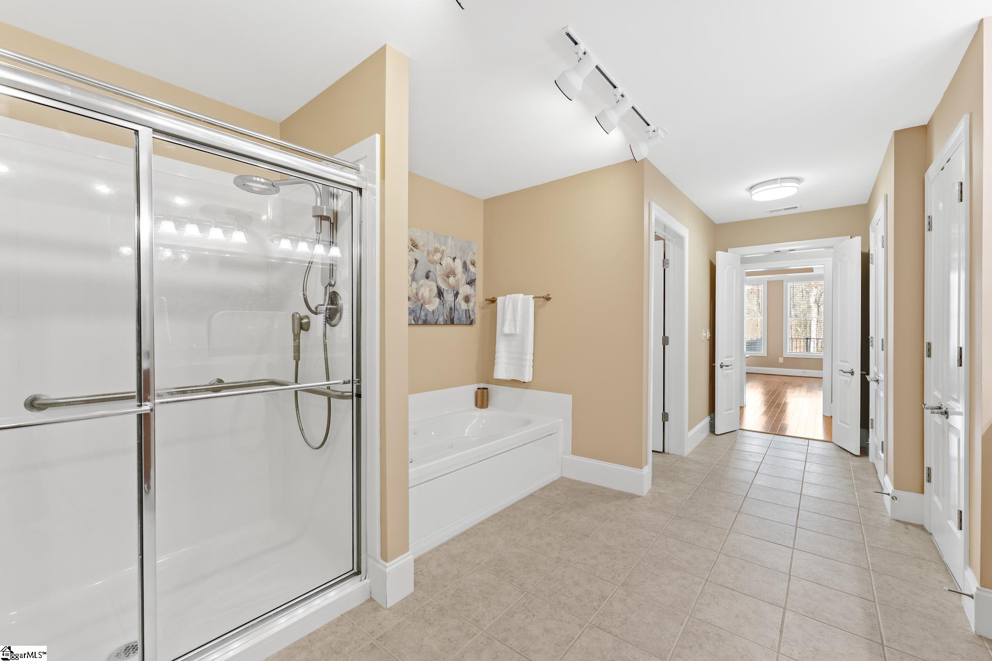 112 P-9-45 Anderson, SC 29625 - Photo 27 of 36 Basement primary bathroom with separate shower and jacuzzi tub, handicap bars, double sinks, closets, tile flooring
