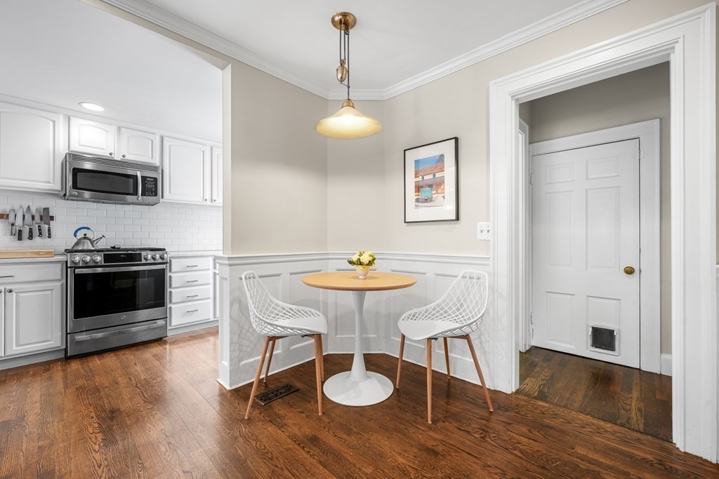 19 Elmwood Road Wellesley, MA 02481 - Photo 14 of 41 a kitchen with stainless steel appliances granite countertop a stove a sink dishwasher a refrigerator with a dining table and chairs