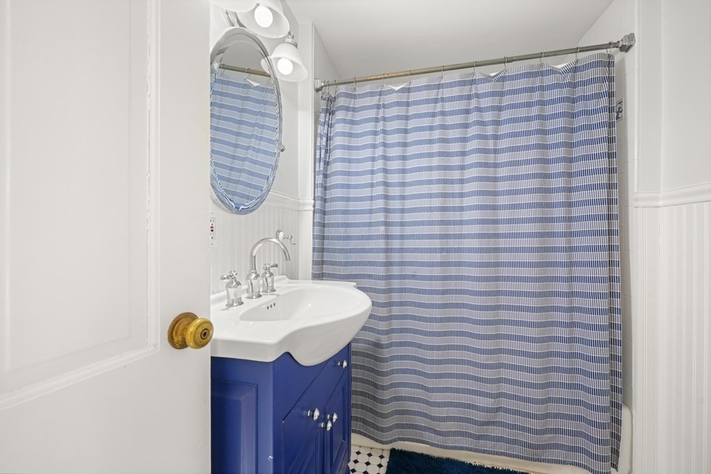 19 Elmwood Road Wellesley, MA 02481 - Photo 32 of 41 a bathroom with a sink a mirror and a shower