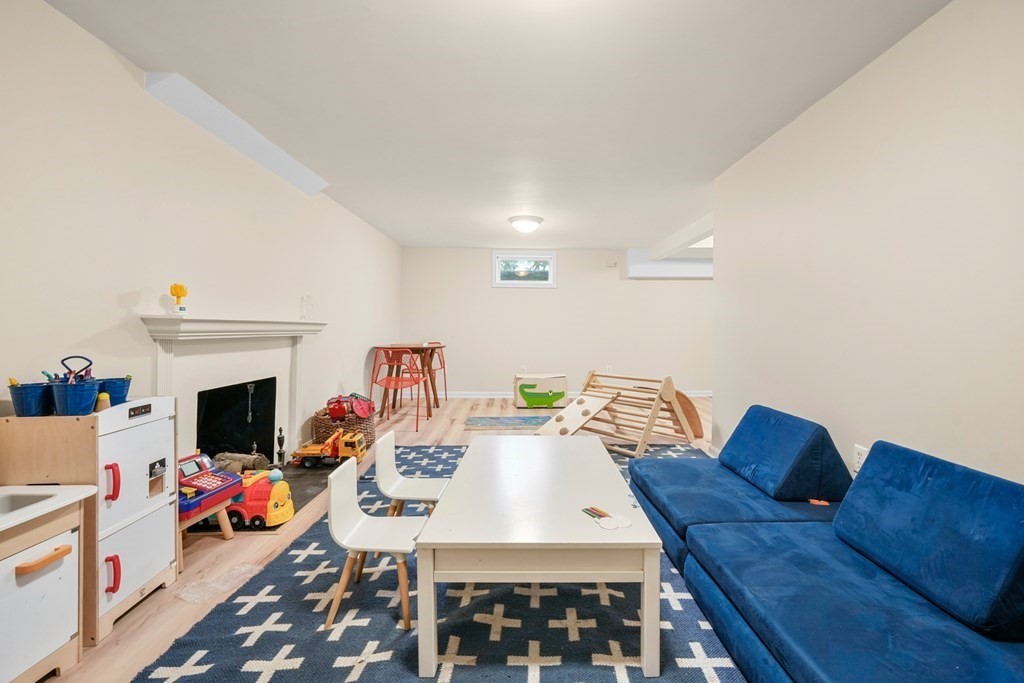19 Elmwood Road Wellesley, MA 02481 - Photo 34 of 41 a view of a livingroom with furniture a fireplace and wooden floor