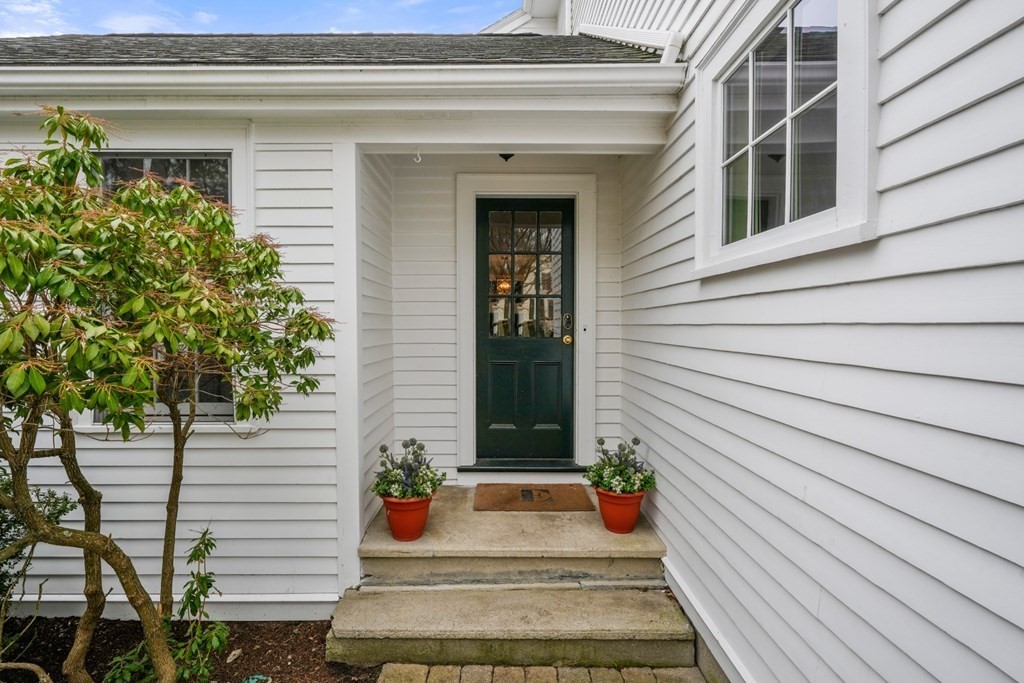 19 Elmwood Road Wellesley, MA 02481 - Photo 4 of 41 a front view of a house with potted plants