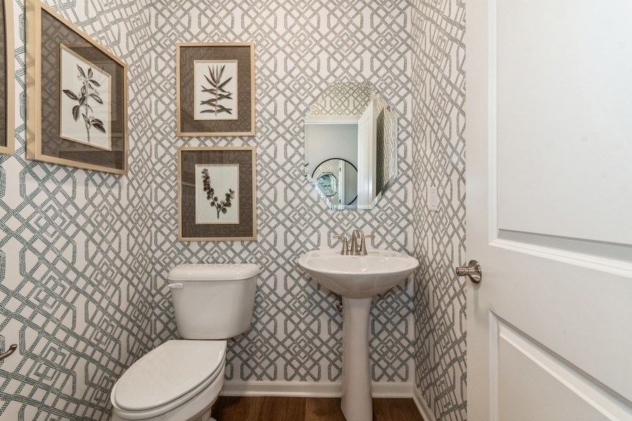 1238 Draper Road McHenry, IL 60050 - Photo 7 of 14 a bathroom with a toilet a sink and a mirror
