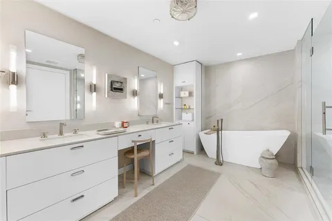 a spacious bathroom with a double sink shower and a mirror