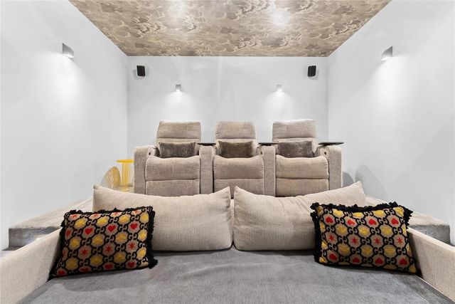 a bathroom with a granite countertop sink a toilet and a mirror