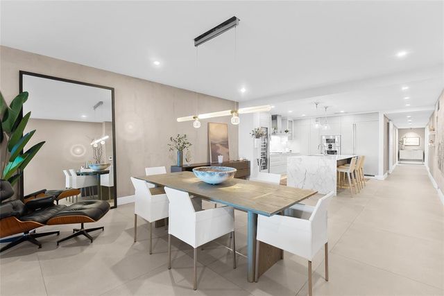 a view of a dining room and livingroom with furniture wooden floor and a rug