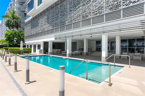 a view of a swimming pool with seating area