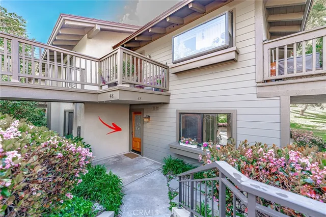 a front view of house and flowers