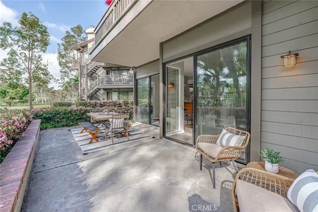 a building outdoor space with patio furniture and potted plants