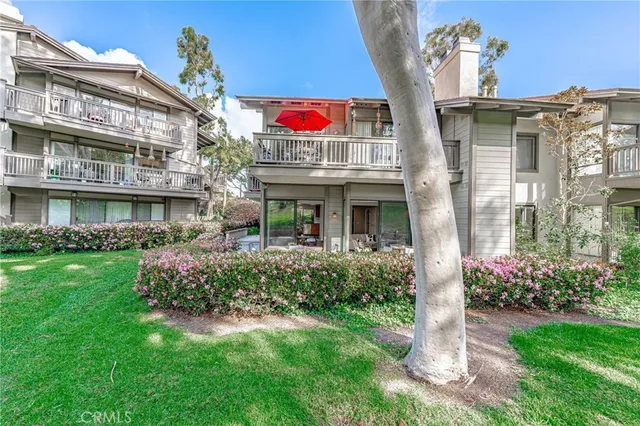 a front view of multi story residential apartment building with yard