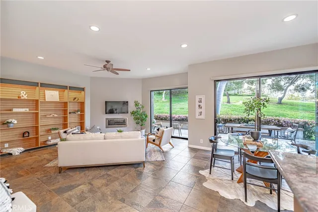 a living room with furniture and large windows
