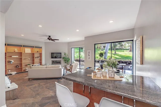 a kitchen with living room and large window
