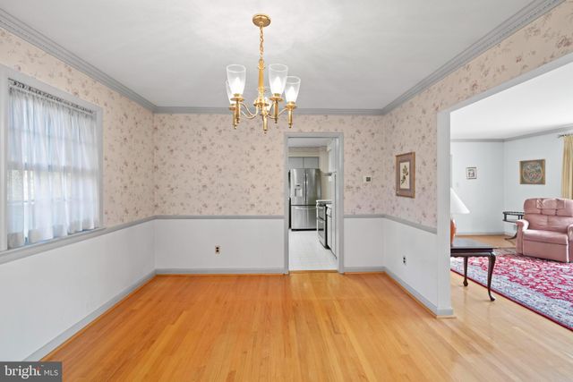 a spacious bedroom with a bed and dresser