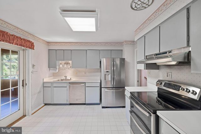 a kitchen with stainless steel appliances a stove sink and refrigerator