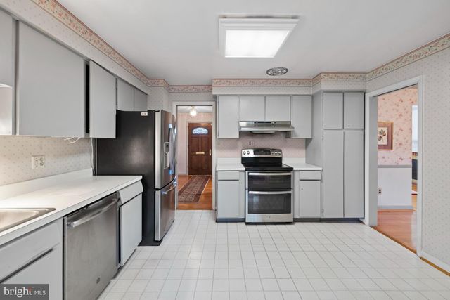a kitchen with stainless steel appliances a sink stove and refrigerator