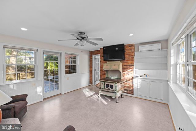 a living room with furniture and large windows