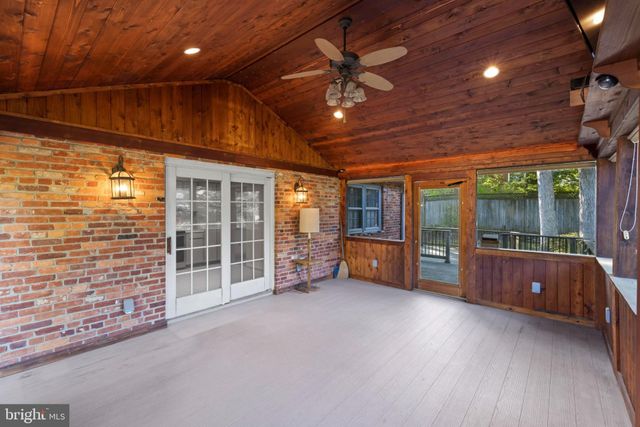 a front view of house with deck and outdoor seating