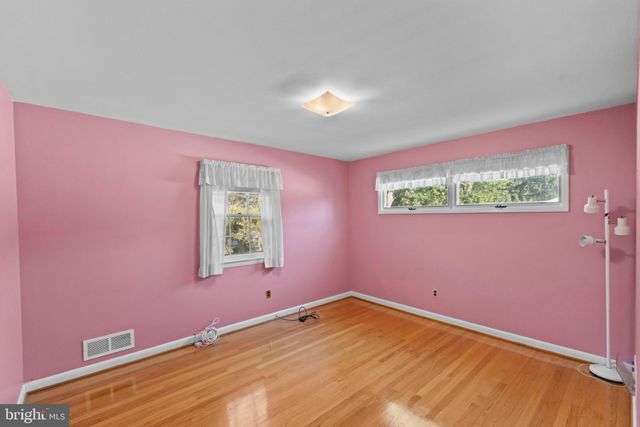 a large bedroom with a bed and dresser