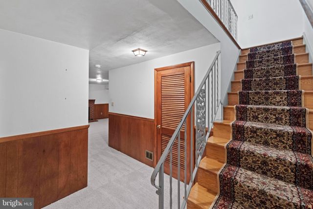 a bathroom with a sink mirror and toilet