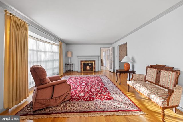 a living room with furniture a rug and a fireplace