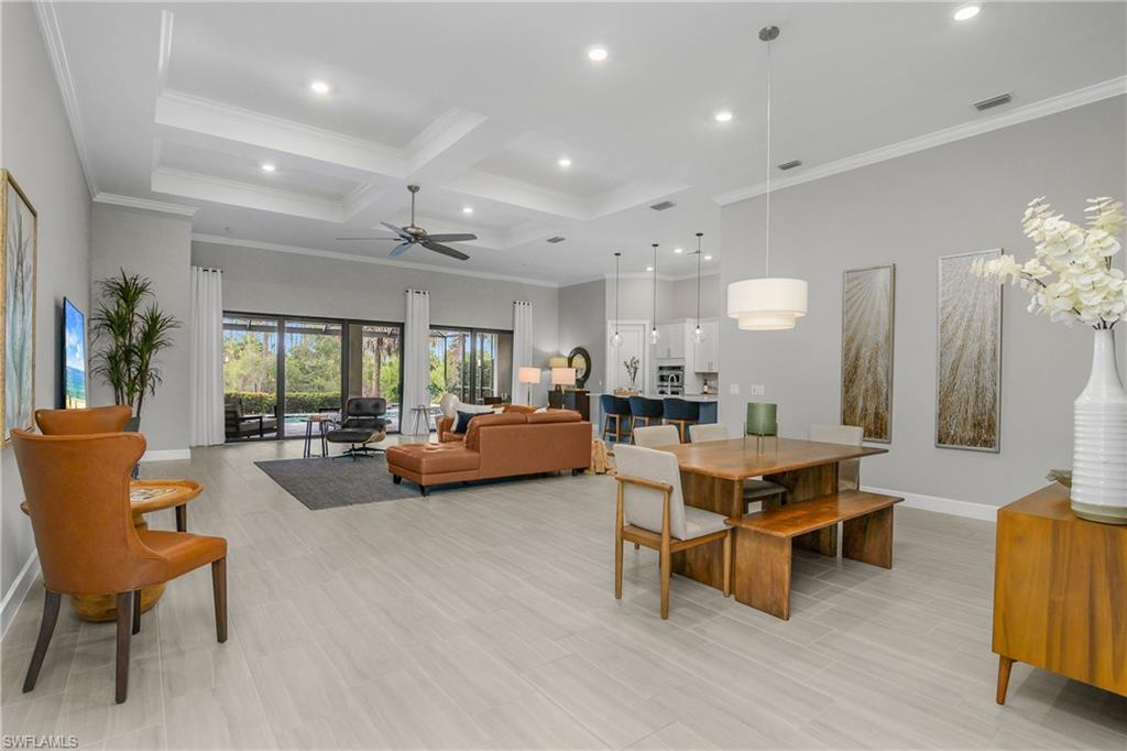 19040 Marquesa Drive Fort Myers, FL 33913 - Photo 9 of 50 Open great room is a huge gathering space with soaring tray ceilings, crown molding, open formal dining room, living room, kitchen cafe area, and kitchen.