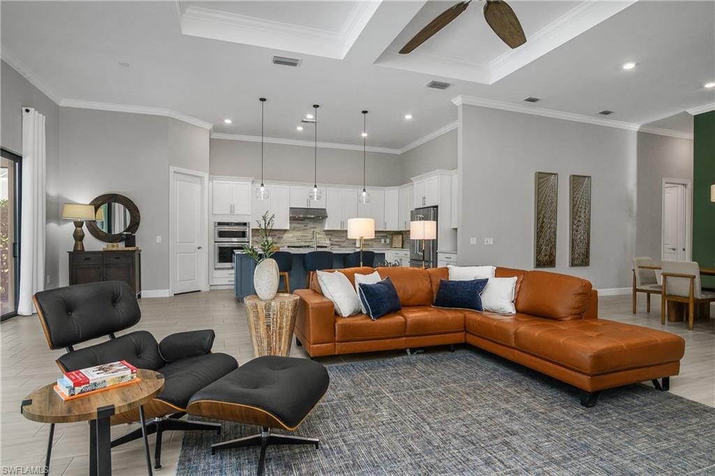 19040 Marquesa Drive Fort Myers, FL 33913 - Photo 12 of 50 Gather with family and friends in this open space, with appetizers and cocktails served at the kitchen island and relaxed conversation in the living/dining areas.