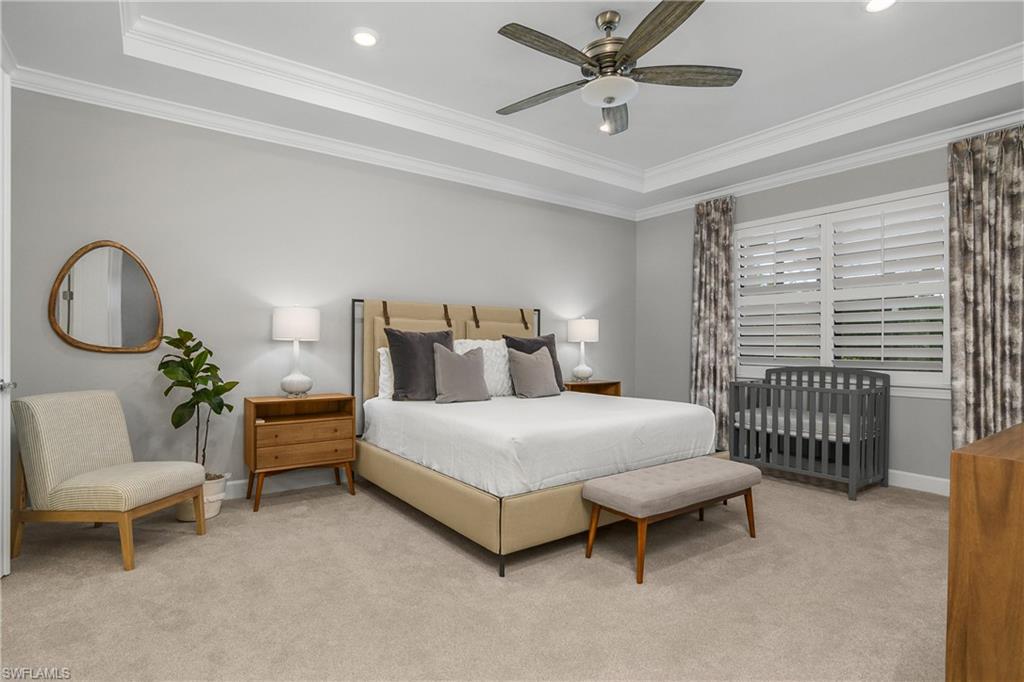 19040 Marquesa Drive Fort Myers, FL 33913 - Photo 19 of 50 Owner suite is quite spacious and features tray ceiling with crown molding, plantation shutters and double entry doors into the spa-like bath.