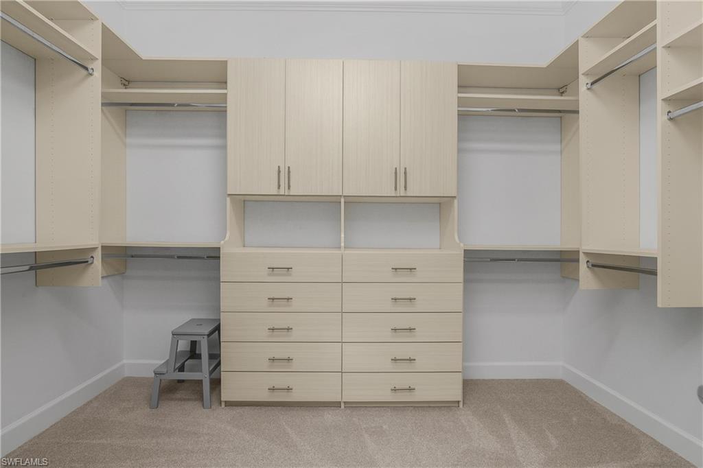 19040 Marquesa Drive Fort Myers, FL 33913 - Photo 23 of 50 Custom Cabinetry in Owner Closet with shelving and drawers for plenty of storage.