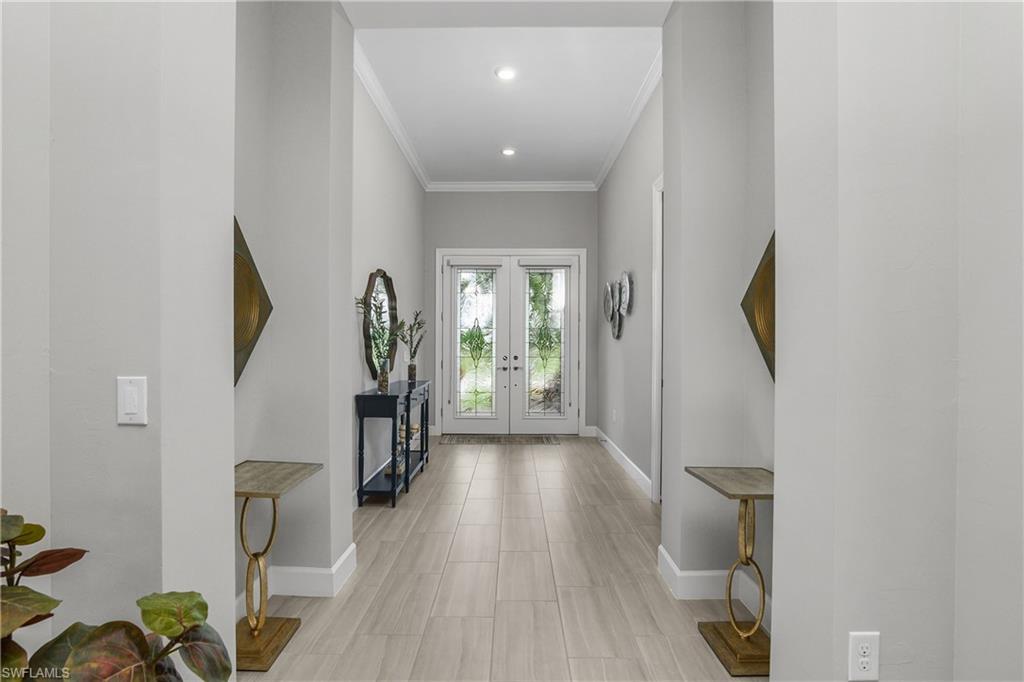 19040 Marquesa Drive Fort Myers, FL 33913 - Photo 2 of 50 Entry foyer is grand and welcoming with double entry doors featuring decorative impact glass.