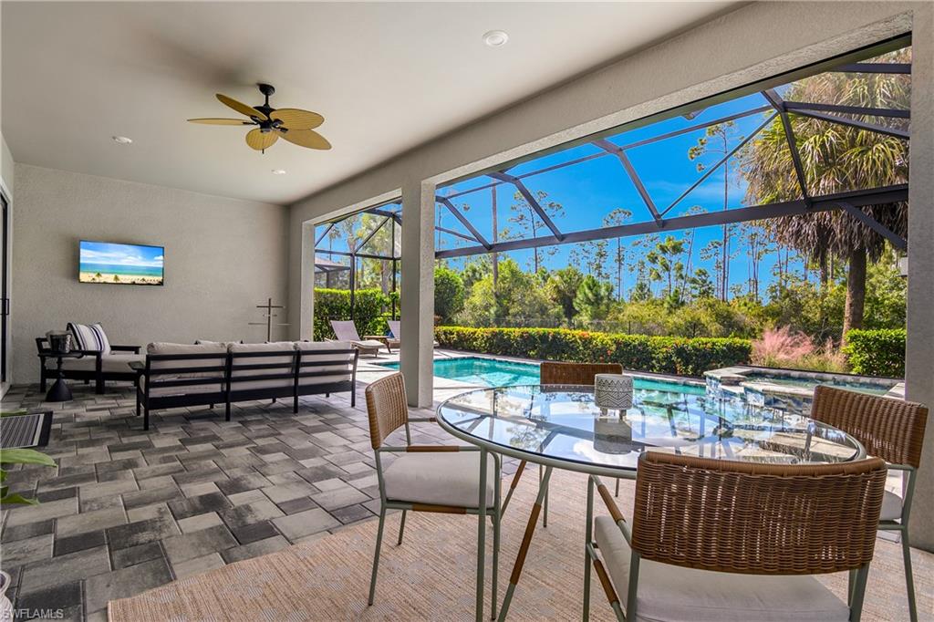 19040 Marquesa Drive Fort Myers, FL 33913 - Photo 30 of 50 Covered Lanai living space is perfect for enjoying evening meals while watching the sunset! Lanai also includes zinga remote sunshades, panoramic screen for unobstructed preserve and sunset views, saltwater pool, and natural gas heater.