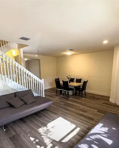 a view of a patio with table and chairs with wooden floor and fence