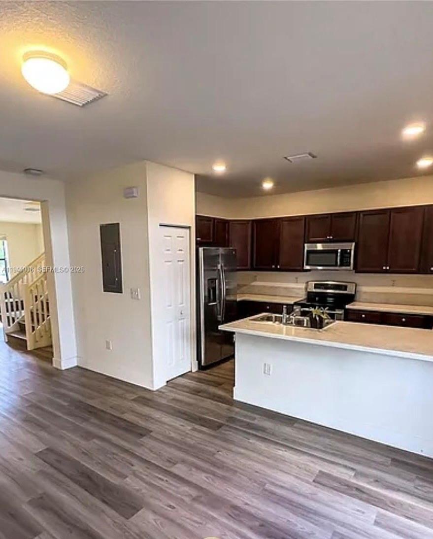 3349 West 105th Terrace, Unit 3349 Hialeah, FL 33018 - Photo 5 of 10 a view of kitchen with stainless steel appliances wooden floor and large window