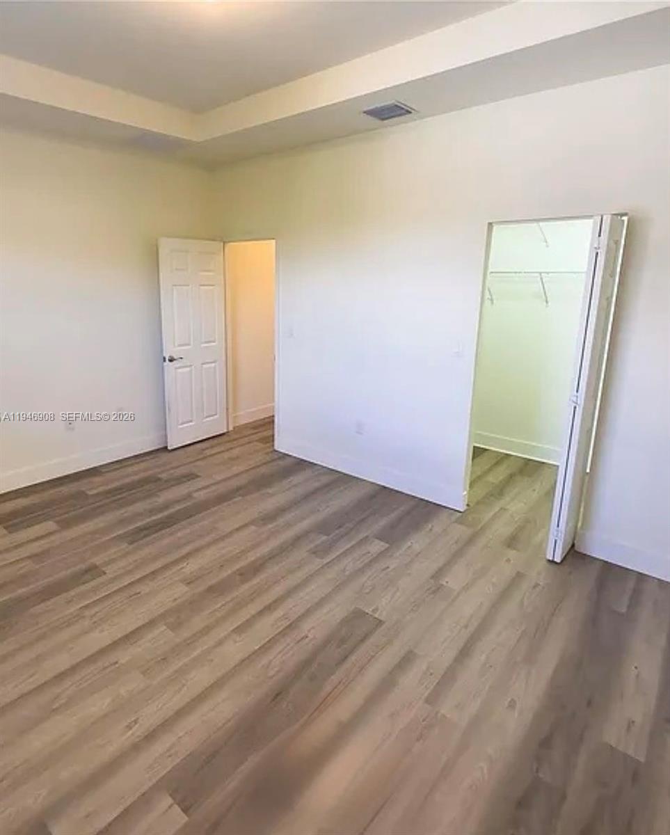 3349 West 105th Terrace, Unit 3349 Hialeah, FL 33018 - Photo 7 of 10 an empty room with wooden floor and closet