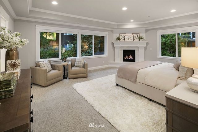 a spacious bedroom with a large bed and a large window