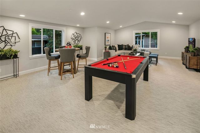 a room with furniture a pool table and a pool table