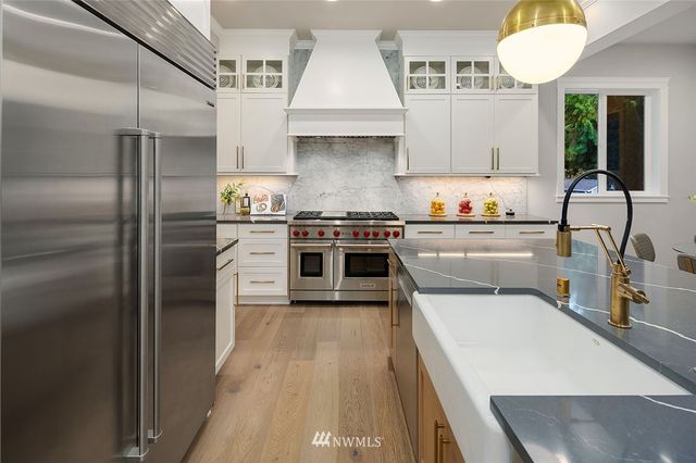 a kitchen with stainless steel appliances granite countertop a stove a sink dishwasher and a refrigerator