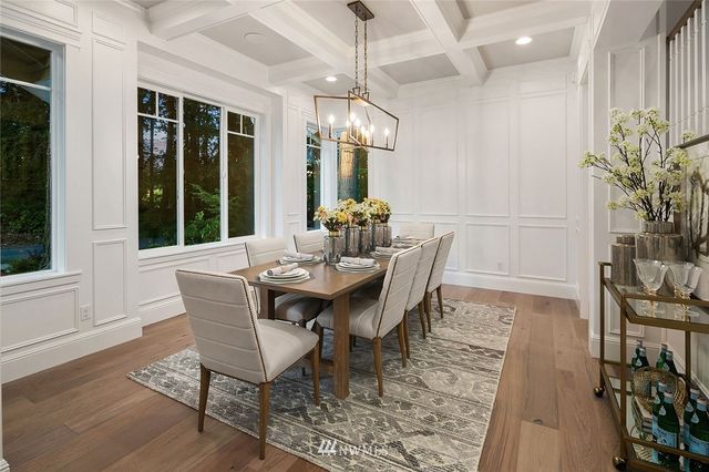 a dining room with furniture a chandelier and wooden floor