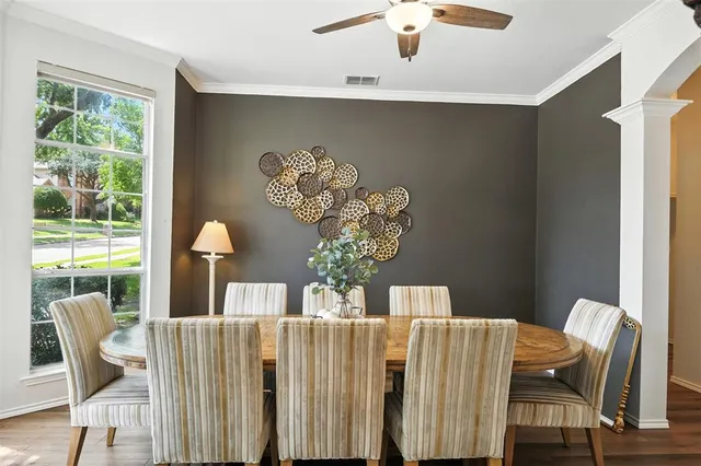 a view of a dining room with furniture and a large window