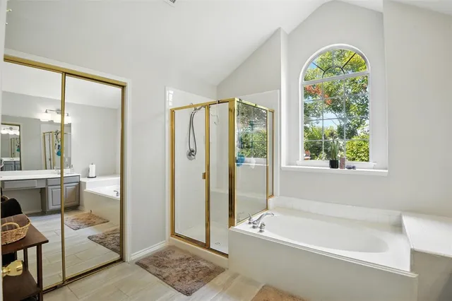 a bathroom with a tub and a shower
