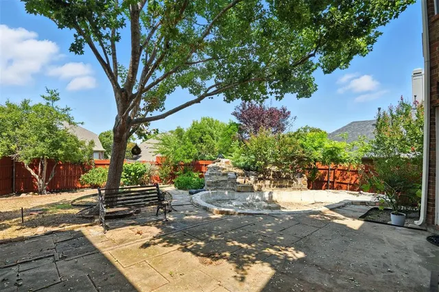 a view of backyard with outdoor seating and trees