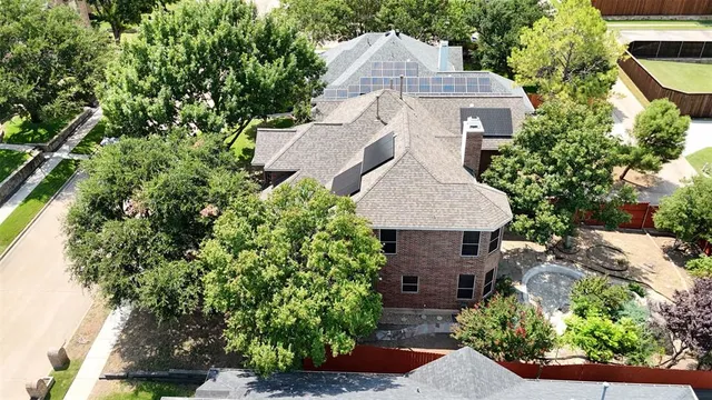 an aerial view of a house with garden space and street view
