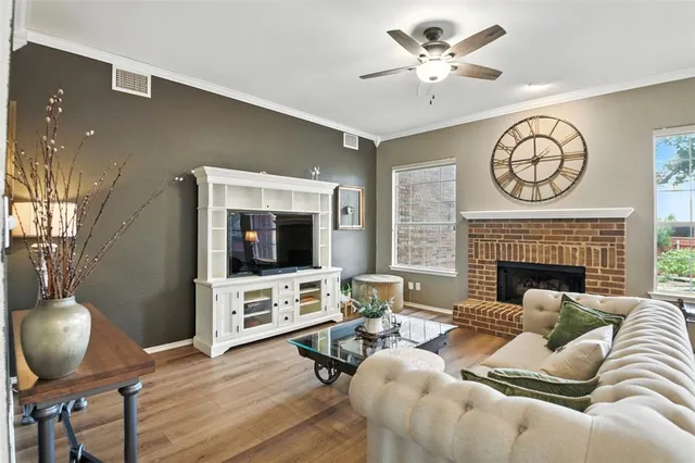 a living room with furniture a fireplace and a flat screen tv