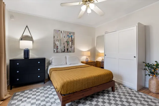 a bedroom with a bed and a lamp