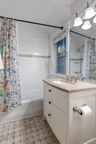 a bathroom with a bathtub and a sink