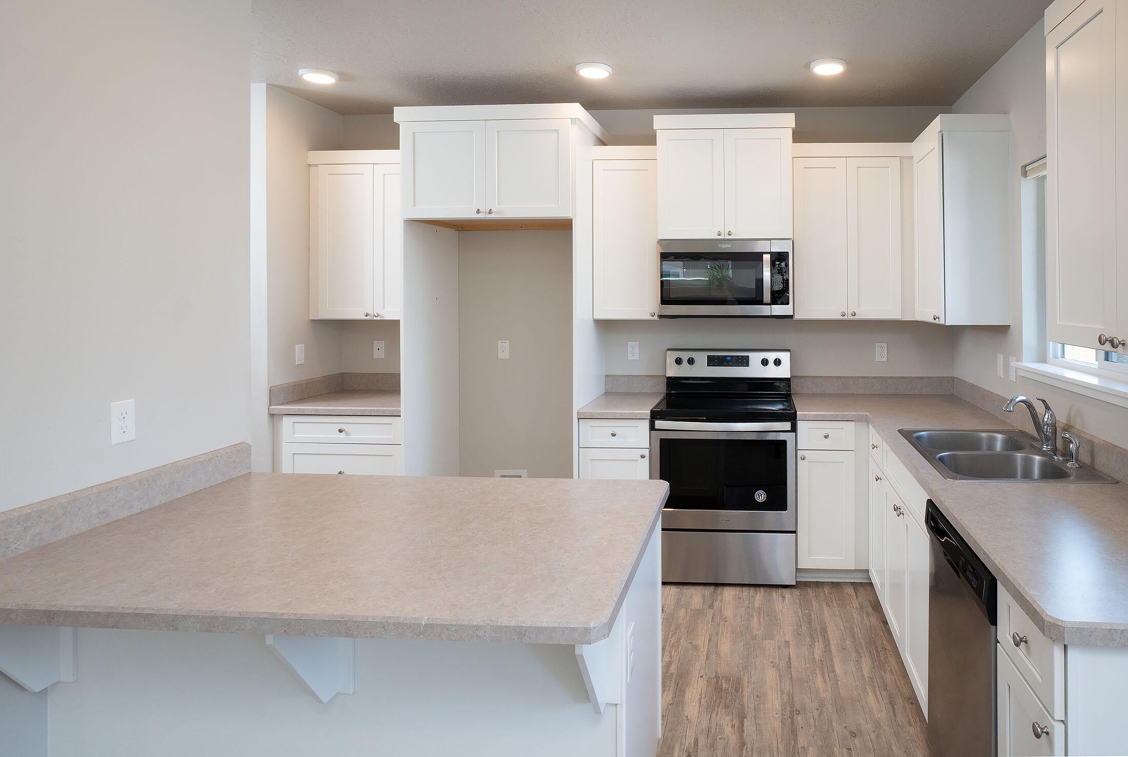 2586 Northeast Colleen Road Prineville, OR 97754 - Photo 6 of 29 Convenient and efficient kitchen features breakfast bar, dishwasher, microwave, and range.