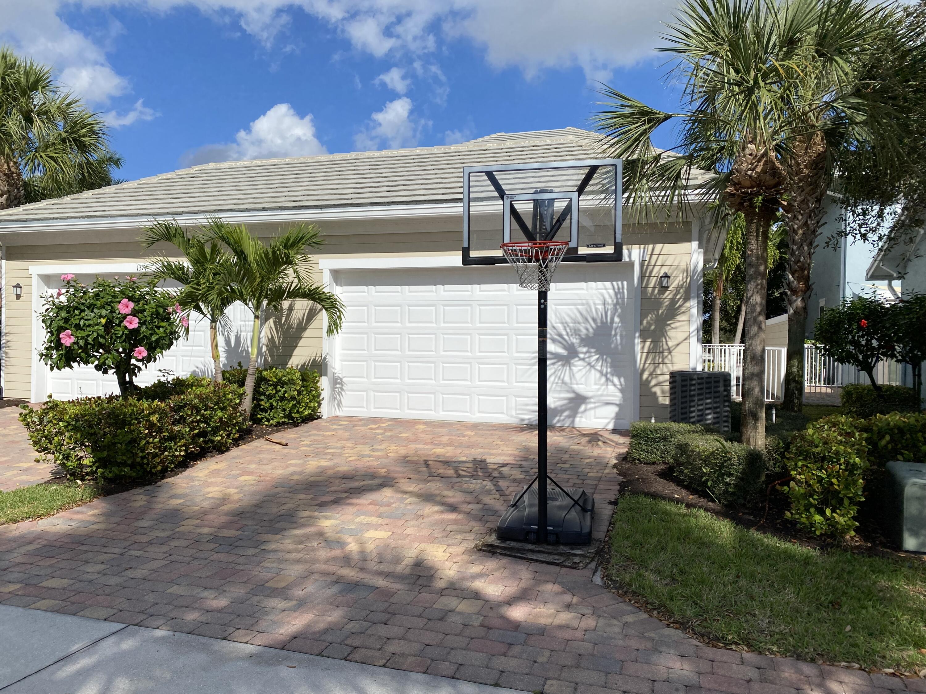1370 Turnbridge Drive Jupiter, FL 33458 - Photo 12 of 12 a front view of a house with garden