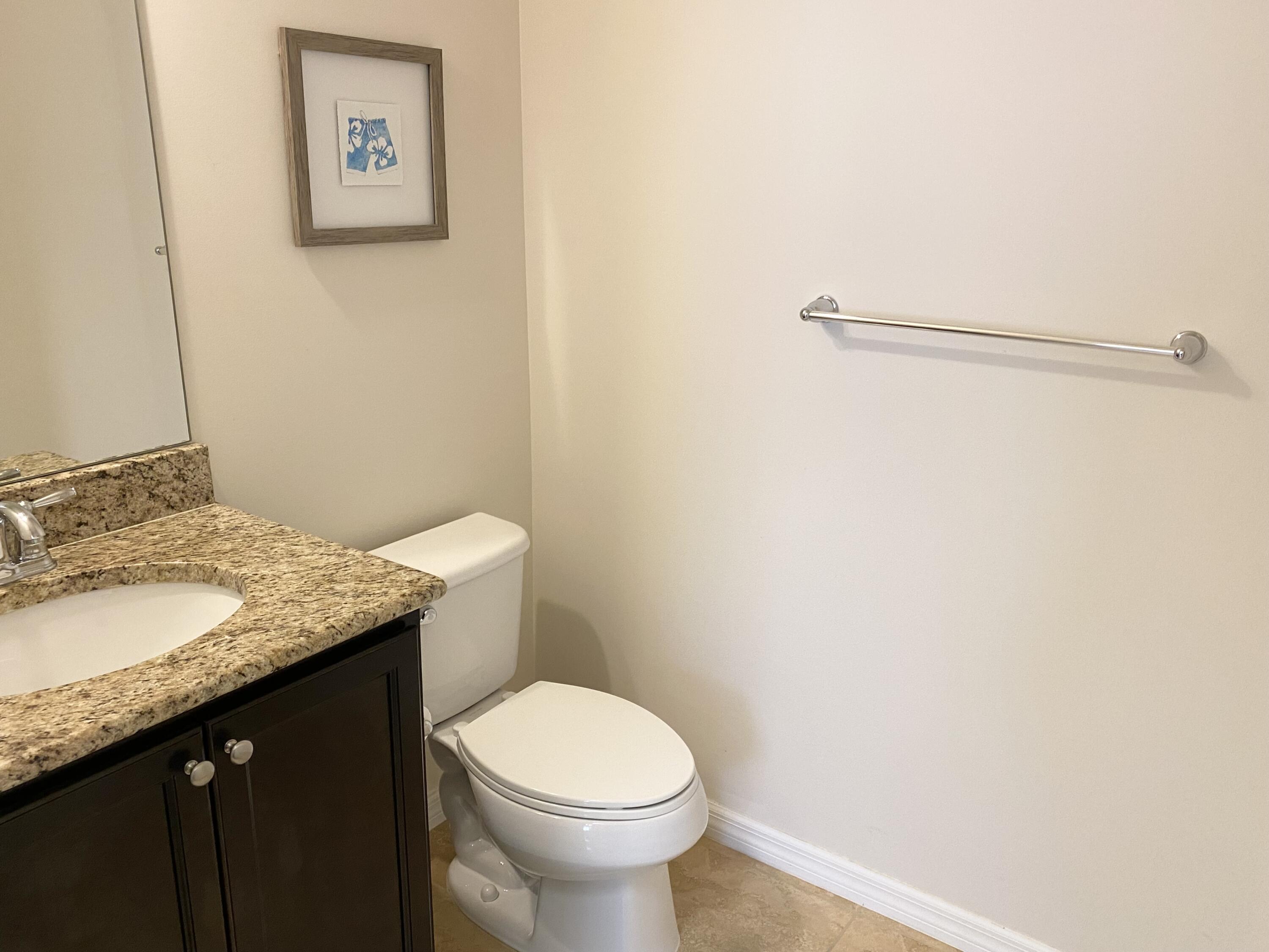1370 Turnbridge Drive Jupiter, FL 33458 - Photo 6 of 12 a bathroom with a granite countertop sink and a toilet