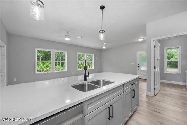 a kitchen with a sink and chandelier